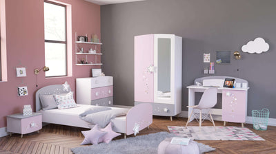 Sfeervolle kinderslaapkamer met roze en grijze wanden, uitgerust met een eenpersoonsbed, bureau, kledingkast en bijpassende ladekasten, versierd met pluchen speelgoed en kinderdecoraties.