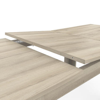 Detail van een uitschuifbare houten tafel met een lichte houtnerf afwerking.